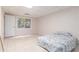 Finished basement bedroom with a window and a comfortable bed with stylish bedding at 1402 Mclendon Dr, Decatur, GA 30033