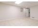 Finished basement bedroom with tiled floors, a window, and a door at 1402 Mclendon Dr, Decatur, GA 30033