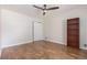 Bright bedroom featuring hardwood floors, a ceiling fan, and ample closet space at 1402 Mclendon Dr, Decatur, GA 30033