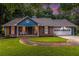 Well-lit home at dusk with cozy front porch and manicured landscaping at 1402 Mclendon Dr, Decatur, GA 30033