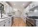 Bright kitchen with white cabinets, stainless steel appliances, hardwood floors, and ample counter space at 1402 Mclendon Dr, Decatur, GA 30033