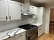 Modern kitchen with white cabinets, granite countertops, and stainless steel appliances at 1402 Mclendon Dr, Decatur, GA 30033