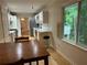 Bright kitchen featuring white cabinets, stainless steel appliances, and an open dining area at 1402 Mclendon Dr, Decatur, GA 30033
