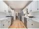 Well-lit kitchen featuring white cabinets, stainless steel appliances, hardwood floors, and marble countertops at 1402 Mclendon Dr, Decatur, GA 30033