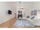 Bright living room with hardwood floors, a fireplace, a ceiling fan, and comfortable seating area at 1402 Mclendon Dr, Decatur, GA 30033