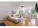 Inviting living room featuring hardwood floors, a ceiling fan, a fireplace, and large windows for natural light at 1402 Mclendon Dr, Decatur, GA 30033