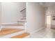 Stairway with hardwood steps and white risers, leading to another level of the home at 1402 Mclendon Dr, Decatur, GA 30033