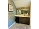 Bathroom vanity with granite countertops, a large mirror, and elegant lighting at 6398 Foggy Oak Dr, Fairburn, GA 30213