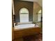 Bathroom featuring a stone-look tub surround and glass shower at 6398 Foggy Oak Dr, Fairburn, GA 30213
