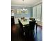 Dining room with ample natural light, dark hardwood floors, and seating for six at 6398 Foggy Oak Dr, Fairburn, GA 30213