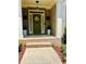 Inviting front entrance with a decorative wreath and olive green door and brick surround at 6398 Foggy Oak Dr, Fairburn, GA 30213
