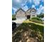 Charming two-story brick home with a well-manicured lawn and a two-car garage at 6398 Foggy Oak Dr, Fairburn, GA 30213