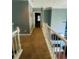 Upstairs hallway with natural light streaming in offers access to other rooms at 6398 Foggy Oak Dr, Fairburn, GA 30213