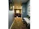 Inviting hallway leading to a cozy living room with comfortable seating and soft lighting at 6398 Foggy Oak Dr, Fairburn, GA 30213