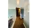 Carpeted hallway featuring white banister and gray walls, offering a neutral and bright transition space at 6398 Foggy Oak Dr, Fairburn, GA 30213