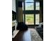 Bright living room featuring a large window, fireplace, and comfortable seating at 6398 Foggy Oak Dr, Fairburn, GA 30213