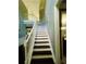 A classic staircase with white railings and dark treads leads to the upper level at 6398 Foggy Oak Dr, Fairburn, GA 30213