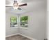 Cozy bedroom featuring hardwood floors, a ceiling fan, and two windows with natural light at 12 Dunwoody Springs Dr # 12, Atlanta, GA 30328