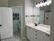 Well-lit bathroom featuring double sinks, white cabinetry, and modern fixtures at 1570 Jami Hollow Way, Lawrenceville, GA 30043