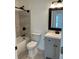 Bathroom with a shower-tub combo, sleek fixtures, and neutral-toned tiling for a modern touch at 1570 Jami Hollow Way, Lawrenceville, GA 30043
