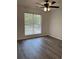 Bright bedroom featuring a ceiling fan and a large window overlooking the front yard at 1570 Jami Hollow Way, Lawrenceville, GA 30043