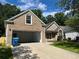 Charming home with brick and vinyl siding, a well-manicured lawn, driveway, and an attached garage at 1570 Jami Hollow Way, Lawrenceville, GA 30043