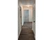 Hallway with hardwood-style floors leading to various rooms, offering a cohesive flow at 1570 Jami Hollow Way, Lawrenceville, GA 30043