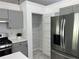 Pantry view in updated kitchen with stainless steel appliances and gray cabinets at 1570 Jami Hollow Way, Lawrenceville, GA 30043