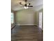 Spacious living room with vaulted ceilings, ceiling fan, and wood-look flooring offers a modern aesthetic at 1570 Jami Hollow Way, Lawrenceville, GA 30043