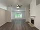 Bright living room with new vinyl floors, a fireplace, a fan and fresh paint at 1570 Jami Hollow Way, Lawrenceville, GA 30043