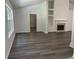 Spacious living room featuring vinyl floors, built in shelving, and a fireplace at 1570 Jami Hollow Way, Lawrenceville, GA 30043