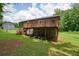 A spacious backyard features a deck with stairs, play structures, and room to roam at 174 Village Dr, Hiram, GA 30141