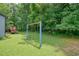 Backyard with a swing set, trees, and lush grass. The perfect place to play at 174 Village Dr, Hiram, GA 30141