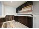 Bar area featuring a wooden backsplash, upper and lower dark brown cabinets, and neutral walls at 174 Village Dr, Hiram, GA 30141