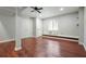 The basement features hardwood floors, a ceiling fan, bright neutral walls, and a daylight window at 174 Village Dr, Hiram, GA 30141