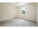 Neutral bedroom with wall-to-wall carpet, a ceiling fan, a large window, and a closet at 174 Village Dr, Hiram, GA 30141
