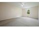 Neutral bedroom with plush carpeting, ceiling fan, and a window for natural light at 174 Village Dr, Hiram, GA 30141
