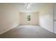 This room is fitted with cozy wall-to-wall carpet, a ceiling fan, and a window for natural light at 174 Village Dr, Hiram, GA 30141