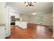 Open kitchen and living area featuring hardwood floors, white cabinets, and stainless steel appliances at 174 Village Dr, Hiram, GA 30141