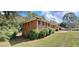 Side view of a brick single-story home with lush landscaping at 3377 Brookfield Ln, Decatur, GA 30032