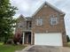 Charming two-story brick home featuring a two-car garage and well-maintained landscaping at 3457 Dacite Ct, South Fulton, GA 30349