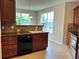 Well-maintained kitchen area with dark wood cabinets, tile backsplash, and bright breakfast nook at 3457 Dacite Ct, South Fulton, GA 30349