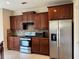 Well-equipped kitchen with stainless steel appliances and ample dark wood cabinetry at 3457 Dacite Ct, South Fulton, GA 30349