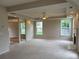 Spacious living room with neutral carpet, fireplace, decorative ceiling, and bright windows at 3457 Dacite Ct, South Fulton, GA 30349