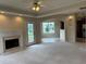 Open living room with fireplace, backyard access, and easy access to kitchen and dining at 3457 Dacite Ct, South Fulton, GA 30349