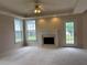 Cozy living room featuring a fireplace, access to the backyard, and recessed lighting at 3457 Dacite Ct, South Fulton, GA 30349