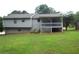 A view of the back of the house and yard, including a deck with railing and stairs to the ground at 4187 Alaina Cir, Austell, GA 30106