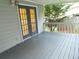 Gray back porch featuring double glass doors and a railing with a view of the backyard at 4187 Alaina Cir, Austell, GA 30106