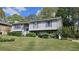 Charming split-level home featuring gray siding, manicured landscaping, and a well-maintained front yard at 4187 Alaina Cir, Austell, GA 30106