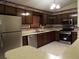 A well-lit kitchen featuring stainless steel appliances, ample cabinet space and vintage wall paper at 4187 Alaina Cir, Austell, GA 30106